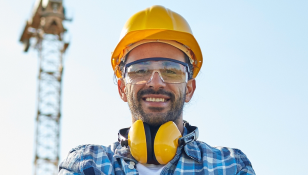 stock-photo-business-building-teamwork-and-people-concept-group-of-smiling-builders-in-hardhats-at-304752239 1