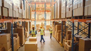 stock-photo-retail-warehouse-full-of-shelves-with-goods-in-cardboard-boxes-workers-scan-and-sort-packages-1848610828 1